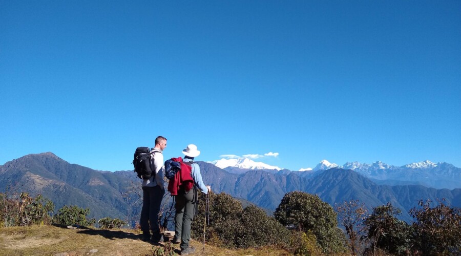 Trekking through the scenic Sikkim Himalayas with lush green landscapes.
