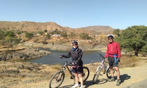 Cyclist Exploring Scenic Villages in Rajasthan on Tour