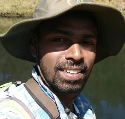 Anoop Jacob, founder of Tropic Trails, smiling outdoors.